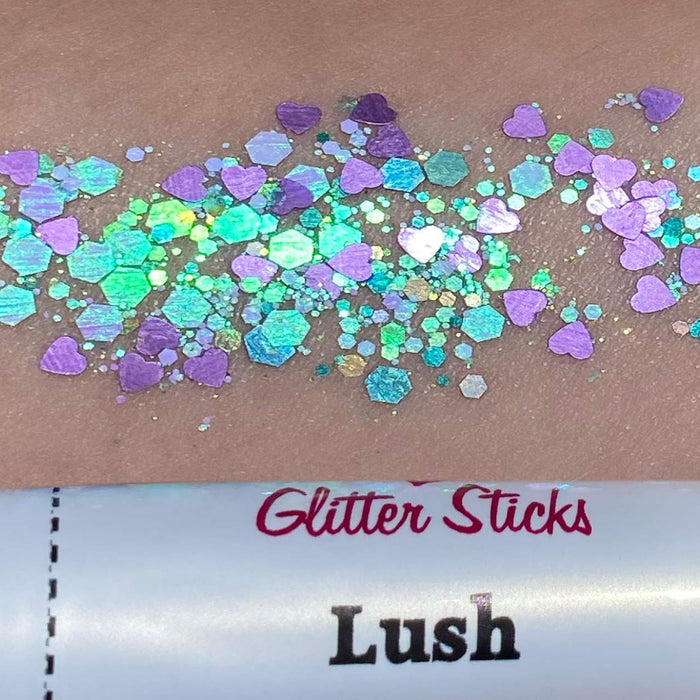 Faces Glitter Sticks with an assortment of multicolored glitter sticks spread around on a surface.
