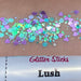 Faces Glitter Sticks with an assortment of multicolored glitter sticks spread around on a surface.