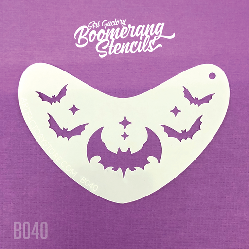 A white stencil with bat shapes on it, placed on a purple background.