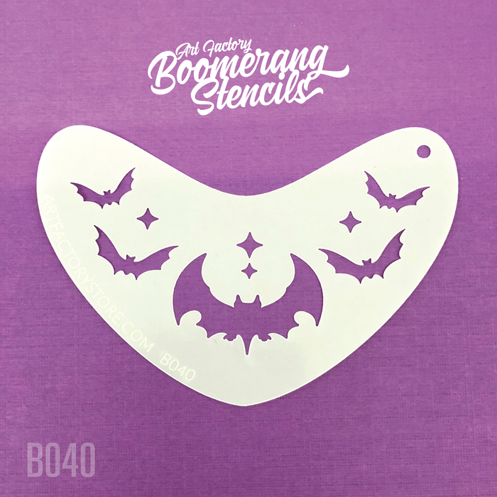A white stencil with bat shapes on it, placed on a purple background.